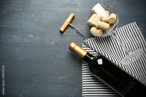 Bottle of wine and corks on wooden table
