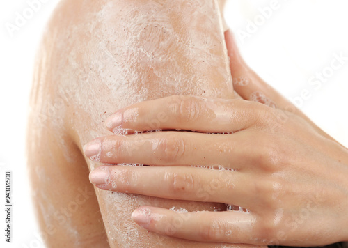 Woman using body scrub isolated on white