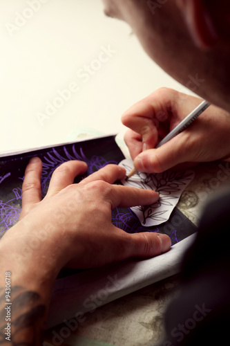 Professional tattoo artist drawing sketch