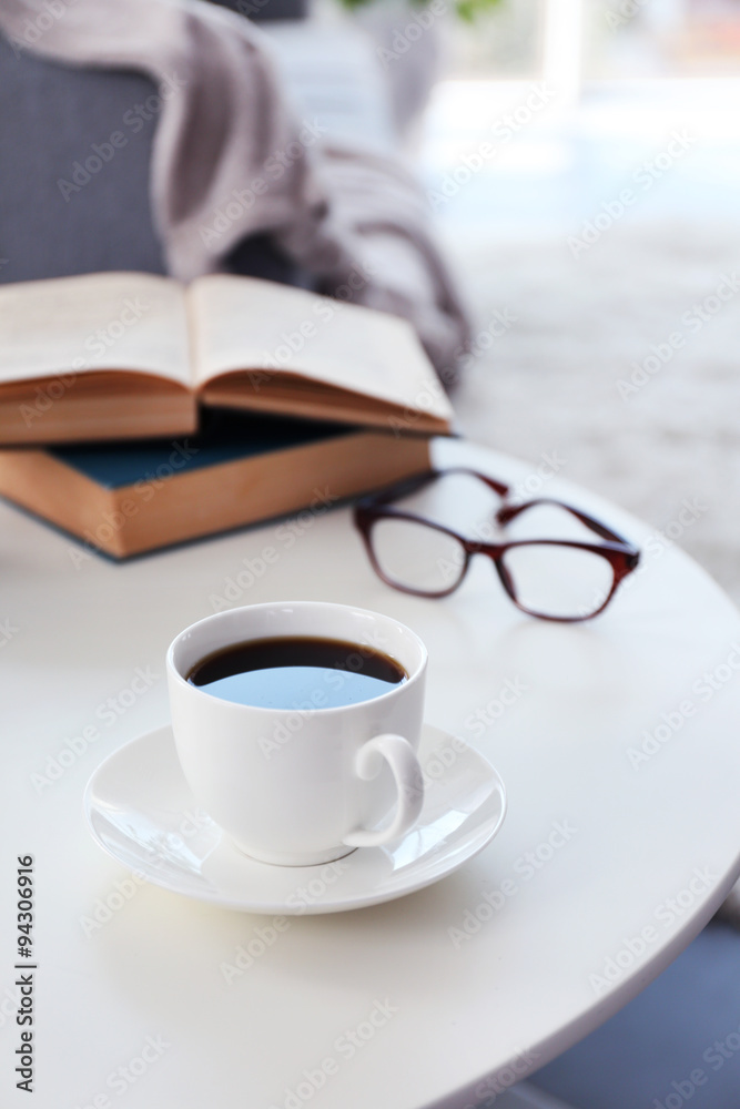 Cup of coffee with books on table in room Cup of coffee with books on table in room
