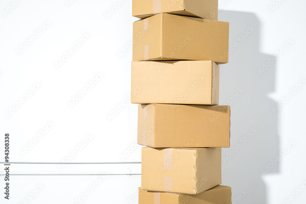 Pile of cardboard boxes on white background with box shadow Pile of cardboard boxes on white background with box shadow