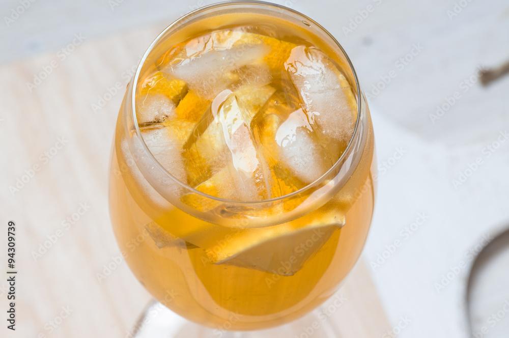 Wineglass of white sangria with lemon and ice Wineglass of white sangria with lemon and ice
