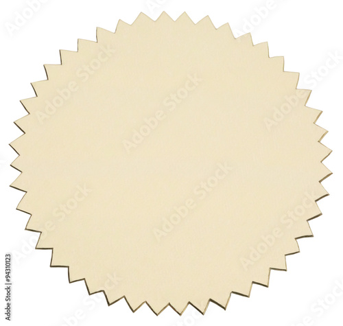 Gold foil sticker with serrated edge. View of obliquely from above. Object is isolated on white background without shadows.