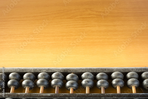 Some part of the abacus placed on a wooden table