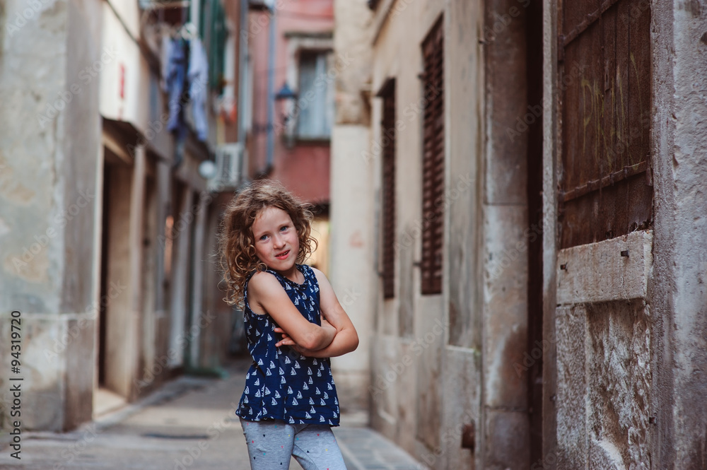 child girl walking old street on vacation in Piran, Slovenia