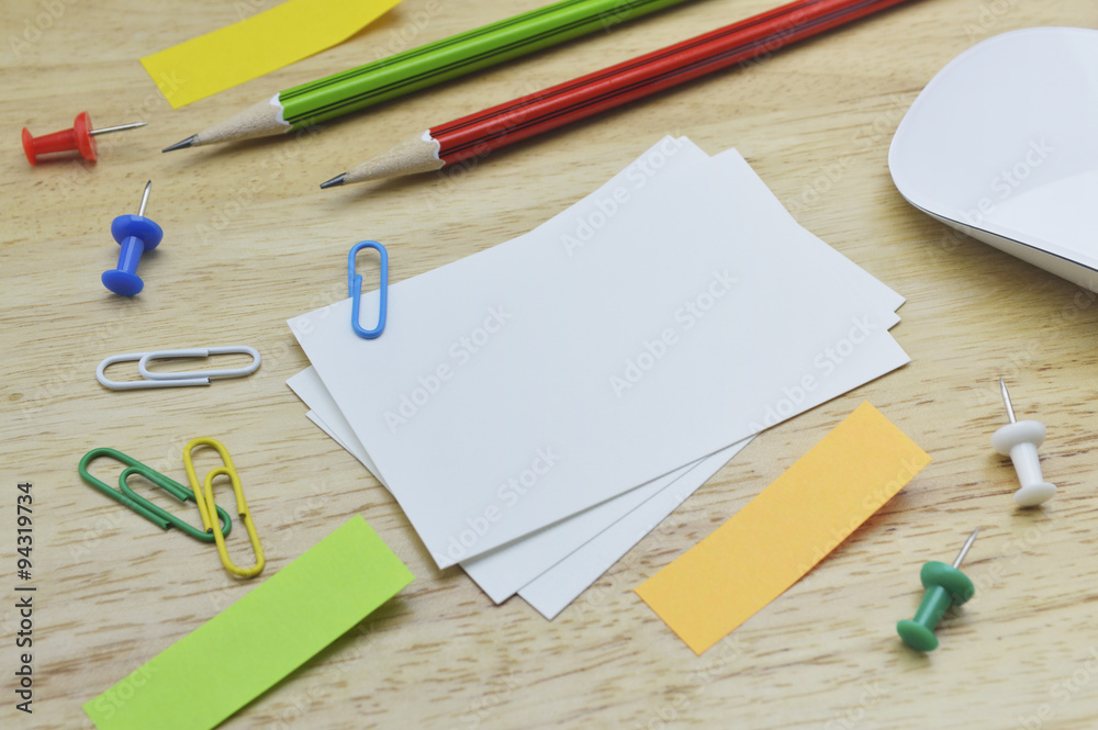 Paper notes, pencil, clip and mouse on table Paper notes, pencil, clip and mouse on table