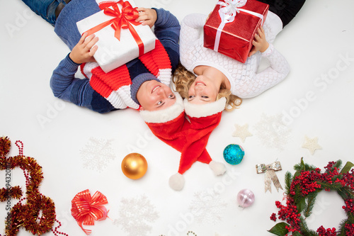 Lovely christmas couple lying with presents