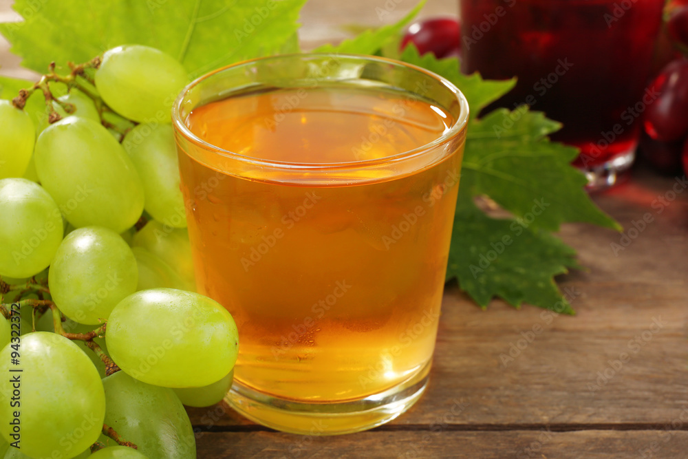 Glass of grape juice on wooden table, closeup Glass of grape juice on wooden table, closeup