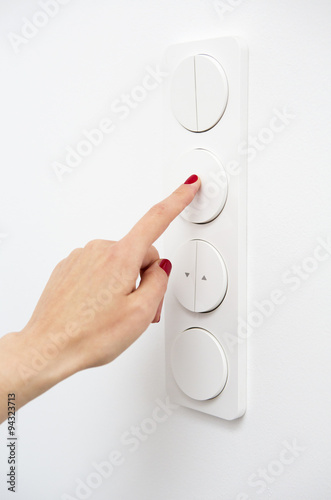 woman's finger on light switch