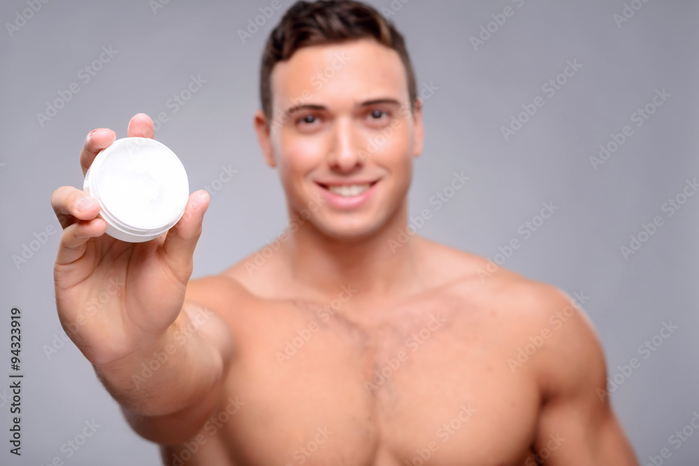 Pleasant man using cream Pleasant man using cream
