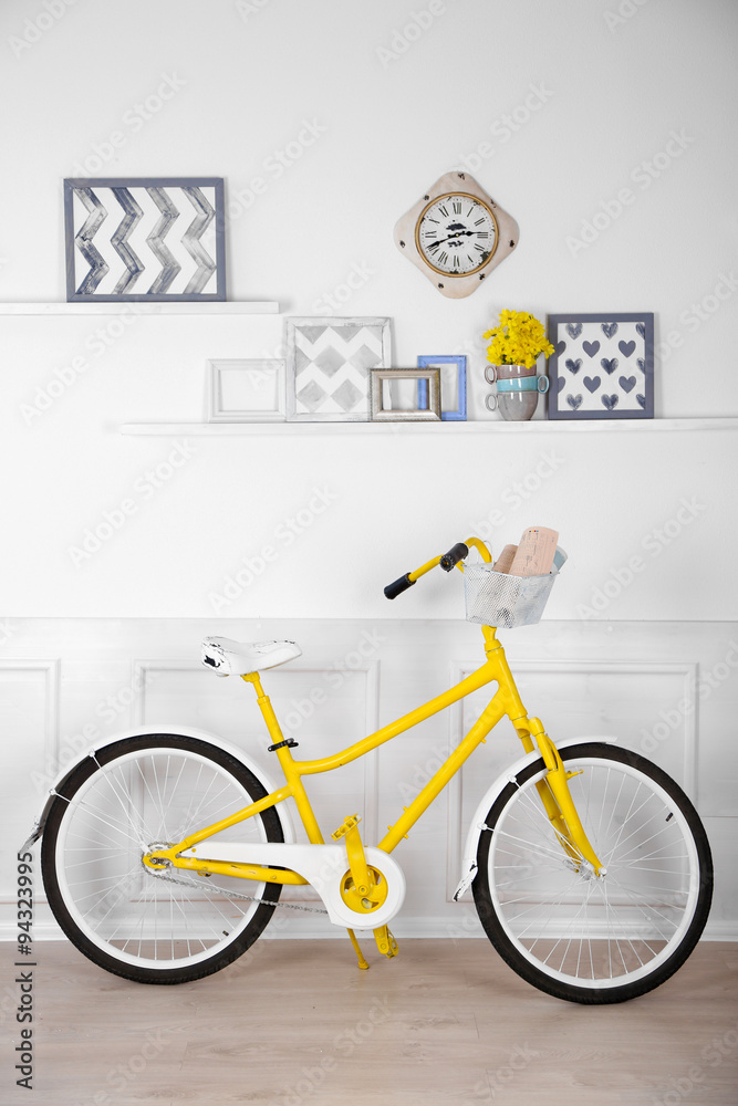 Yellow retro bicycle in spacious bright room Yellow retro bicycle in spacious bright room