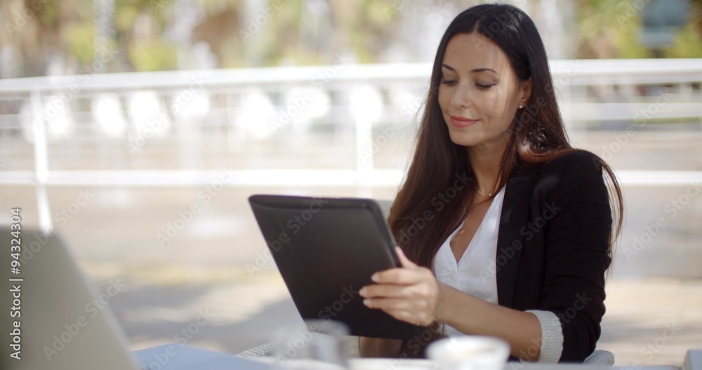 Pretty businesswoman working on a tablet Pretty businesswoman working on a tablet