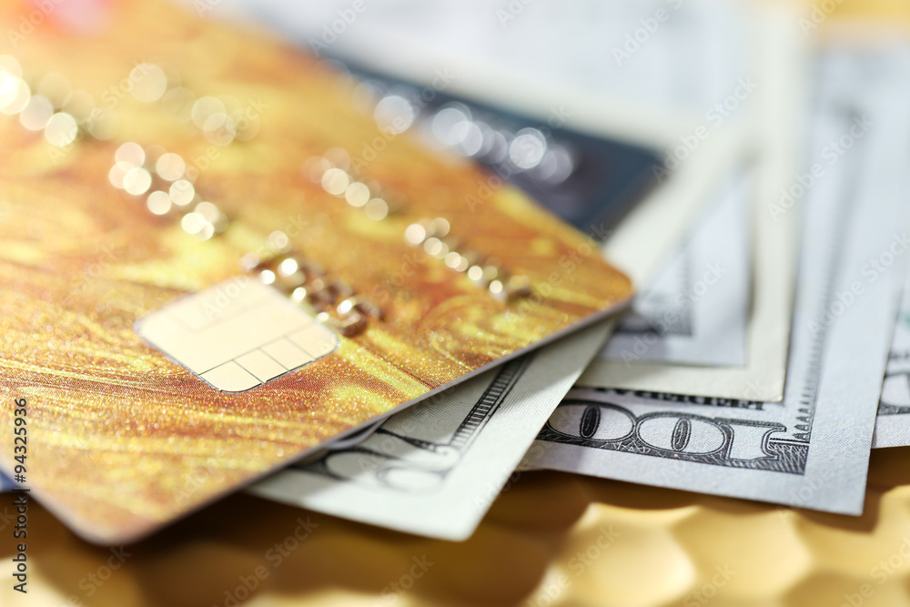 Credit cards and dollars on golden background Credit cards and dollars on golden background