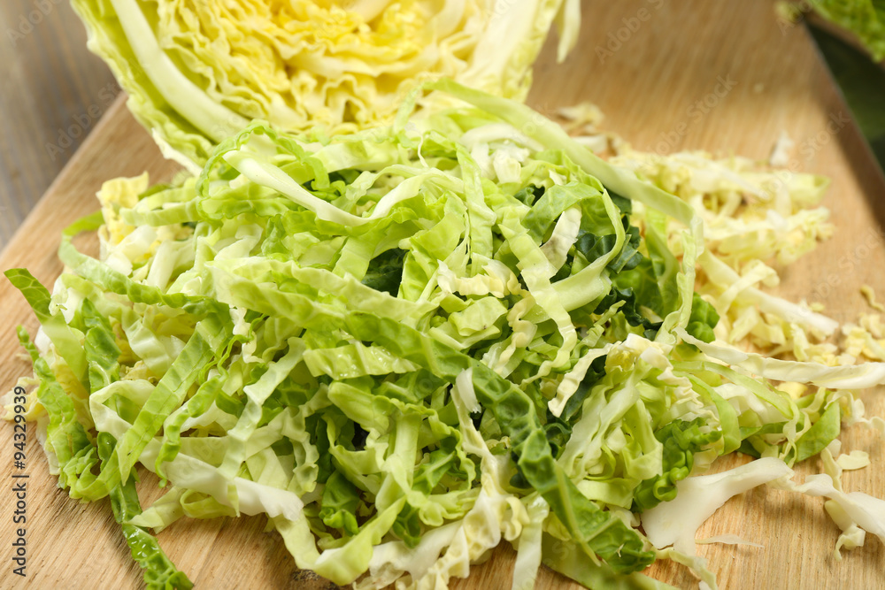 Cut savoy cabbage on cutting board closeup Cut savoy cabbage on cutting board closeup