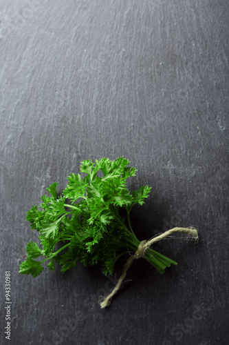 Fresh parsley on dark grey background