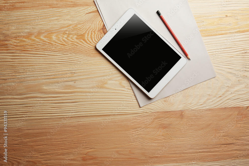 White tablet on wooden background White tablet on wooden background