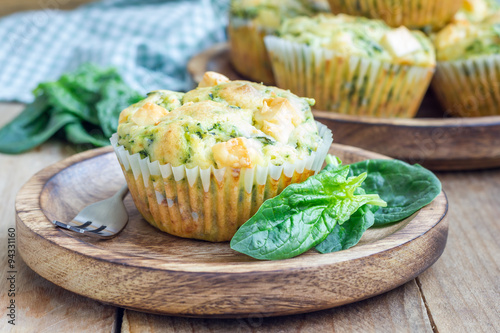 Photography Snack muffins with spinach and feta cheese on a wooden plate
