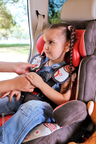 Cute little girl sitting in...