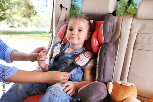 Cute little girl sitting in...