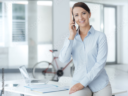 Smiling business woman having a phone call © stokkete