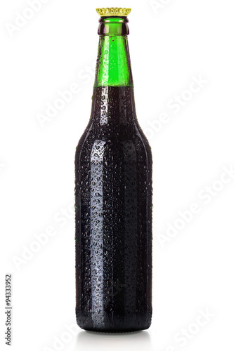 Bottle of beer with drops isolated on white