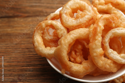 Chips rings in bowl on wooden background