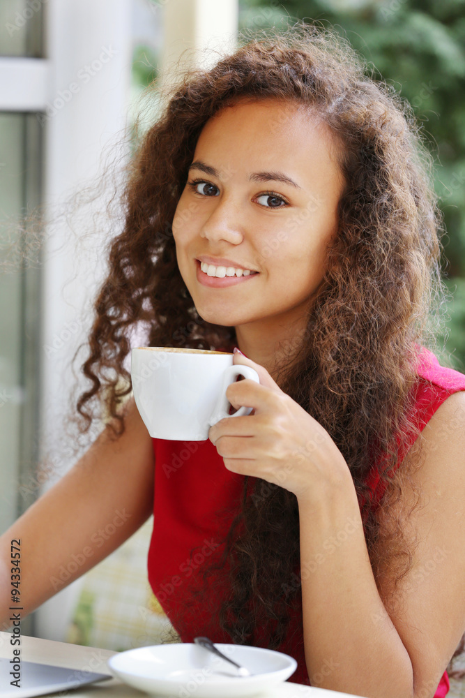 Close up portrait of young pretty woman drinking coffee Close up portrait of young pretty woman drinking coffee