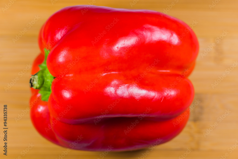 Red bell pepper on wooden table Red bell pepper on wooden table