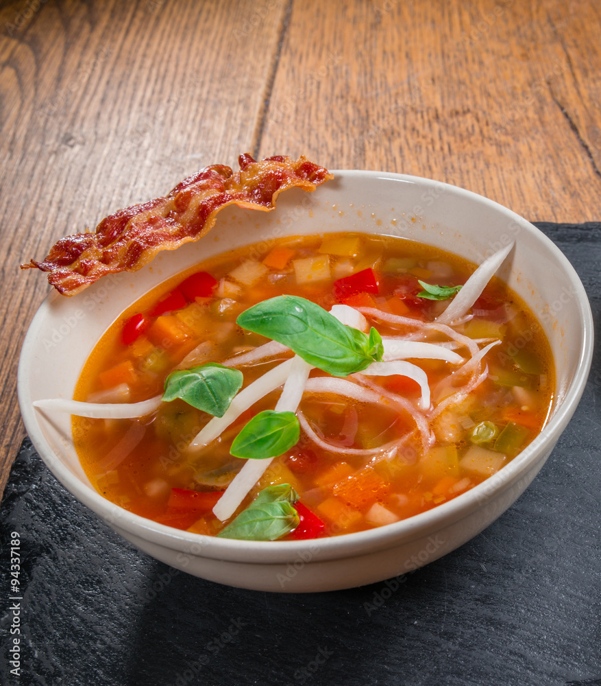 Vegetable soup served with crisp bacon Vegetable soup served with crisp bacon