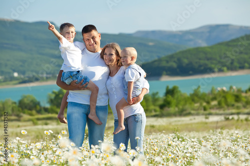 Happy family are walking in camomile field  © nuzza11