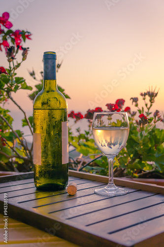 The bottle of wine and glass  cork in the sunset light. Sardinia  Italy. Summer-2015.