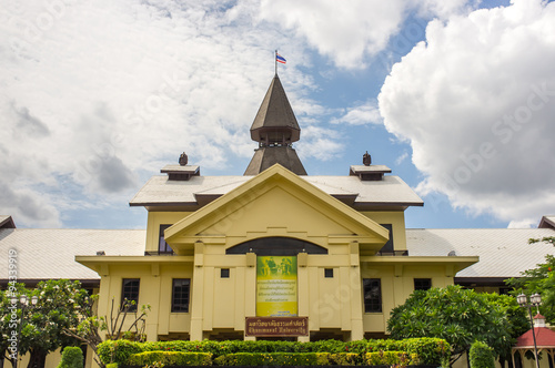 A yellow building with Thailand flag on the roof at Thammasat university, Bangkok  photo