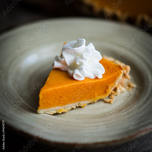 Pumpkin pie on rustic wooden background