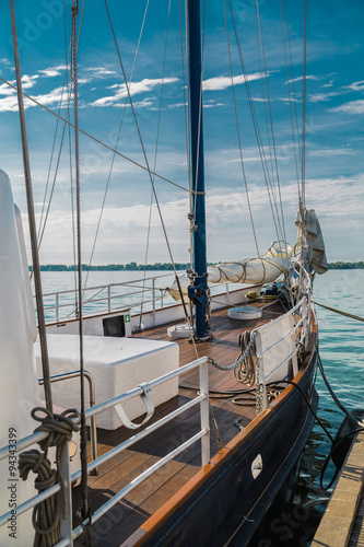 amazing gorgeous stunning inviting partial view of tall vintage old ship nose against turquoise tranquil lake and blue sky background