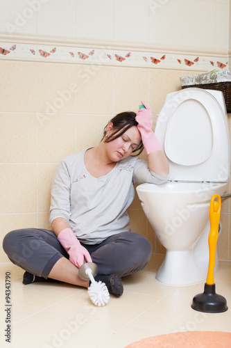 Tired housewife at the toilet