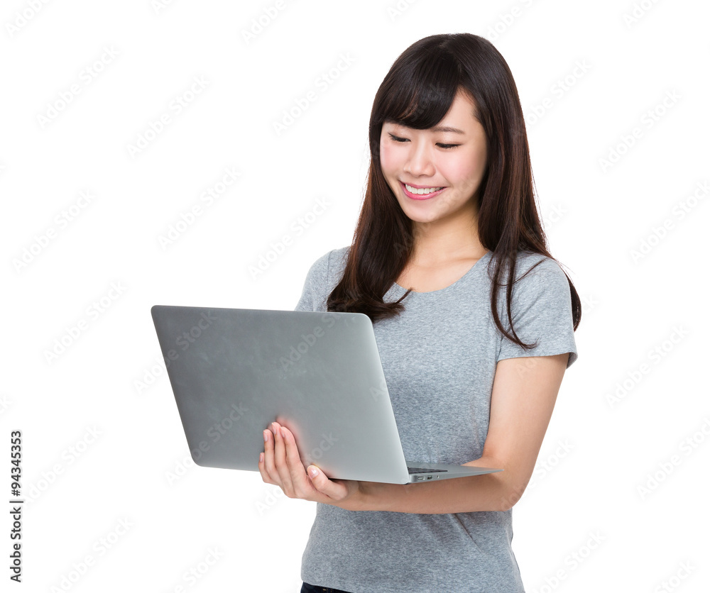 Asian Young woman watch on the laptop computer Asian Young woman watch on the laptop computer