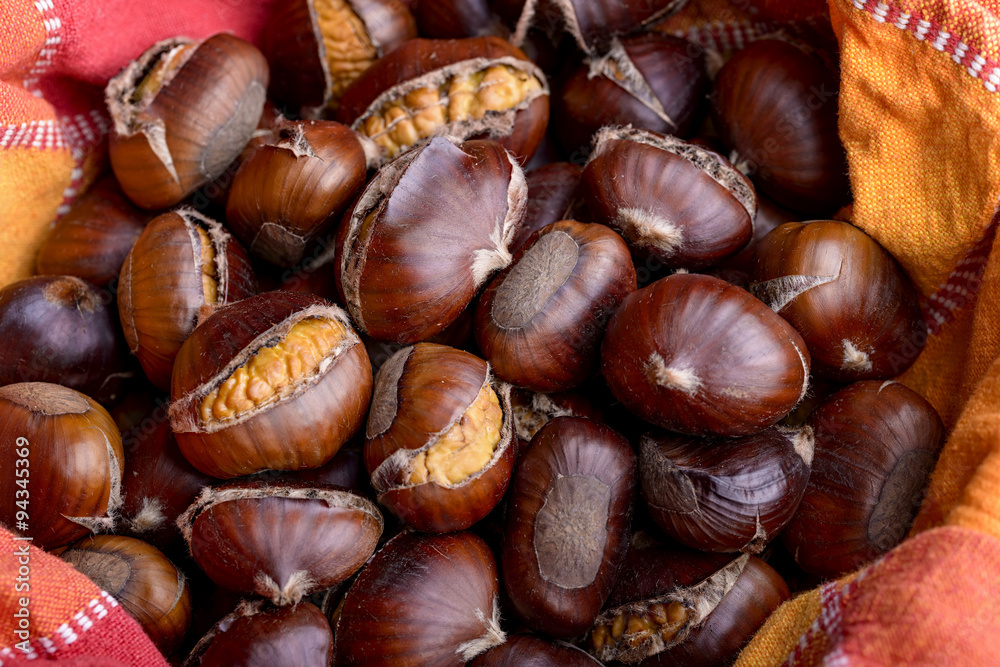 roasted chestnut inside a bowl with cloth napkin roasted chestnut inside a bowl with cloth napkin