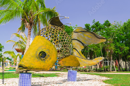 Cayo Coco island, Melia jardines del rey,Cuba, Sep 2, 2015 giant big, decorative beutiful fish made of metal  shits and horshoe parts, standing on ceramic tile posts in cozy tropical garden photo