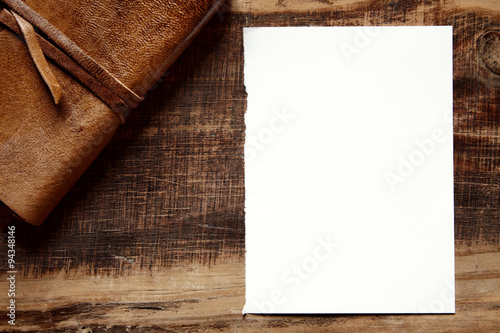 white sheet of paper on a wooden background