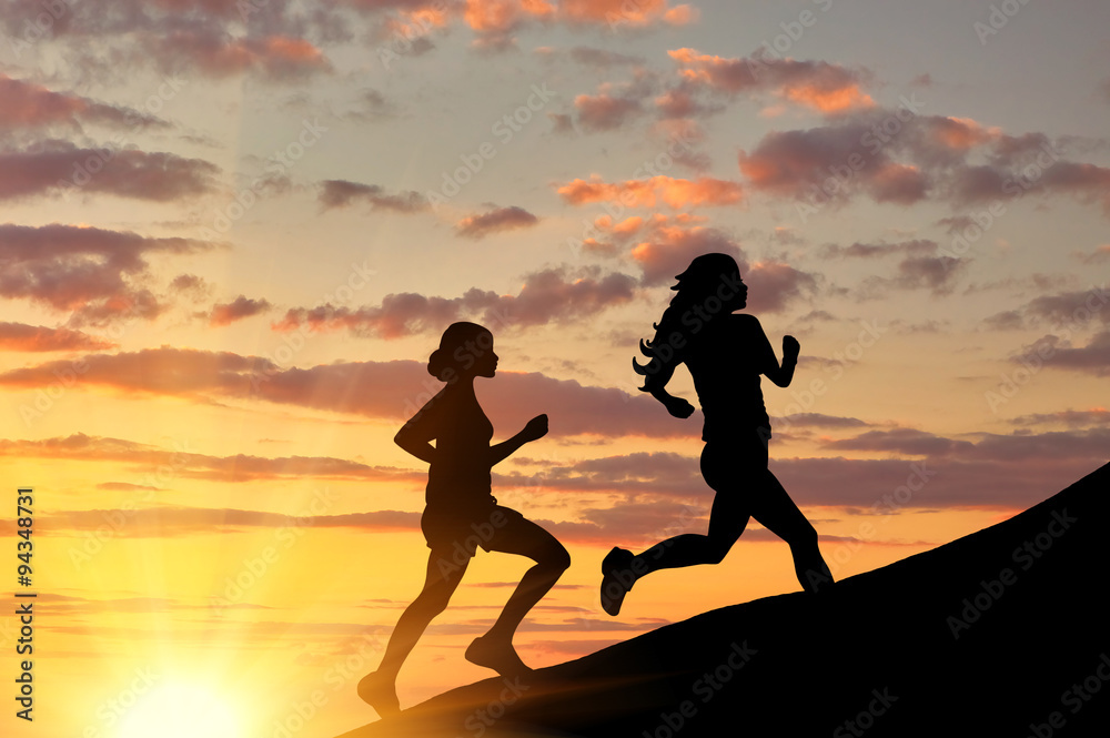  Silhouette of two girls running competition