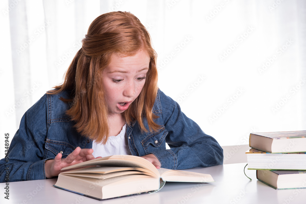 young redhead girl reading in books - she is scared young redhead girl reading in books - she is scared