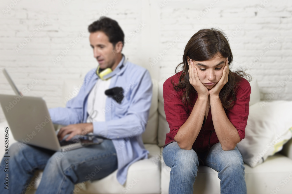 woman bored and frustrated ignored while internet addict husband or boyfriend using digital tablet networking woman bored and frustrated ignored while internet addict husband or boyfriend using digital tablet networking