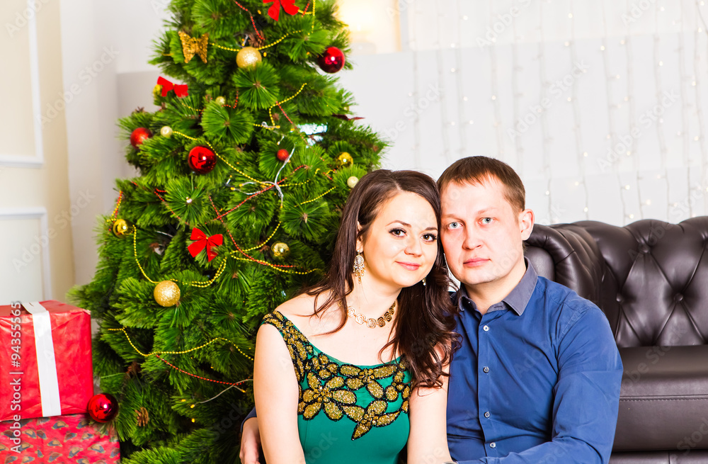 Young happy couple near  a Christmas tree