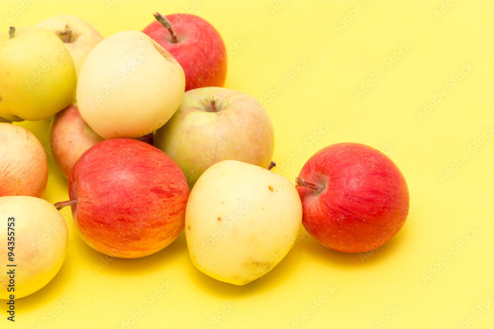 ripe apples on a yellow background