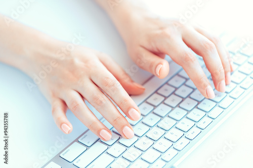 Female hands or woman office worker typing on the keyboard