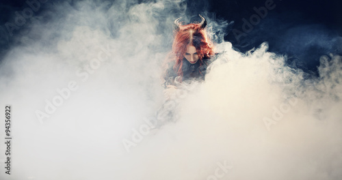 witch at the smoky background. Halloween image.