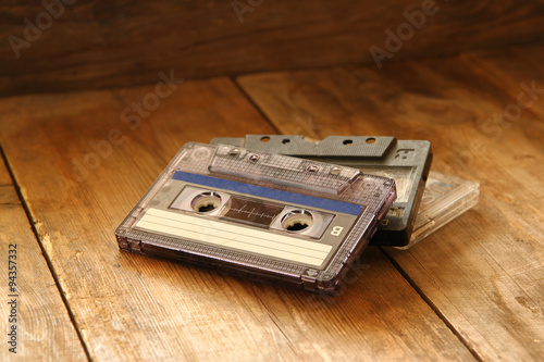 Cassette tape over wooden table. image is instagram style filtered.
