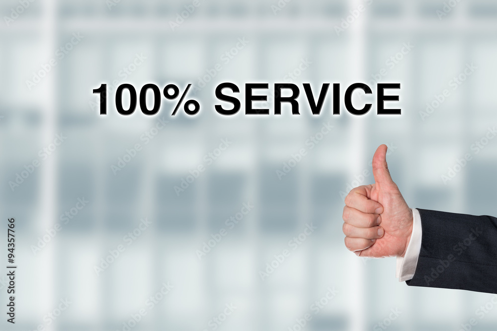 Business man pointing at the words 100% service Business man pointing at the words 100% service