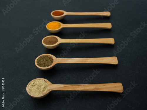 spices over black slate background