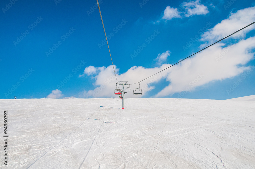 Ski lifts durings bright winter day